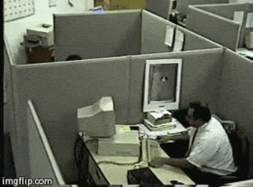 Angry man hitting his computer with his keyboard.
