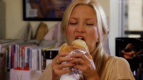 a woman devouring a burger