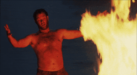 Gif of Tom Hanks in front of a fire saying look what I have created