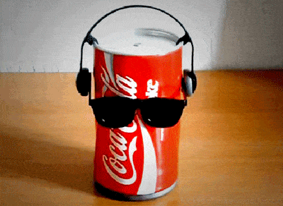 A can of coke with sunglasses and headphones.
