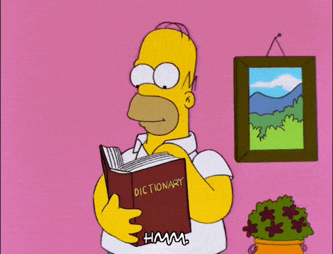 Homer Simpson looking for some domain name inspiration in a dictionary.