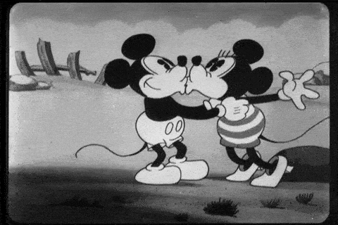 Mickey and Minnie kiss each other.