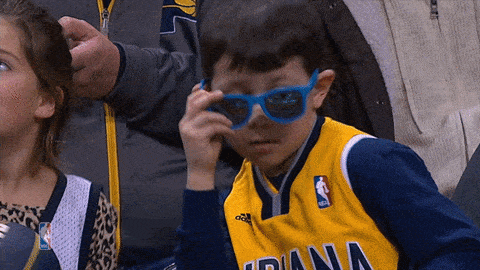 A child takes off his glasses.