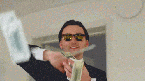 A man throws dollar bills.